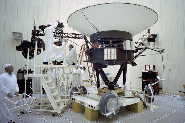 The Voyager 2 spacecraft, seen here being worked on by NASA engineers in 1977, has traveled more than 12 billion miles from Earth.